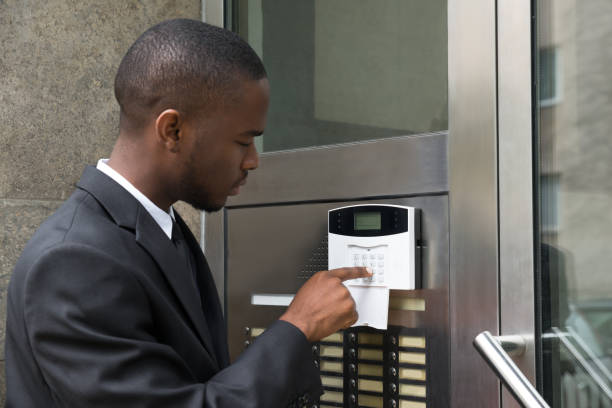 Young African Businessman Entering Code In Security System Young African Businessman Entering Code In Security System
